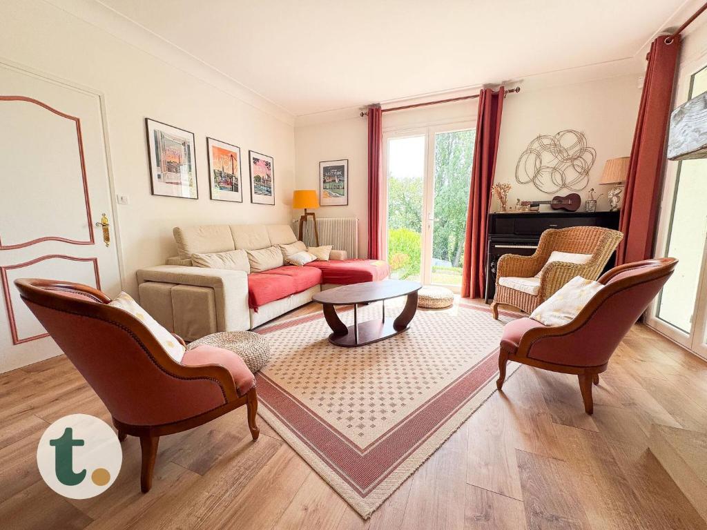 a living room with a couch and a table and chairs at Tranquiloue - Halte Nature Proche du PuyduFou in Saint-Laurent-sur-Sèvre
