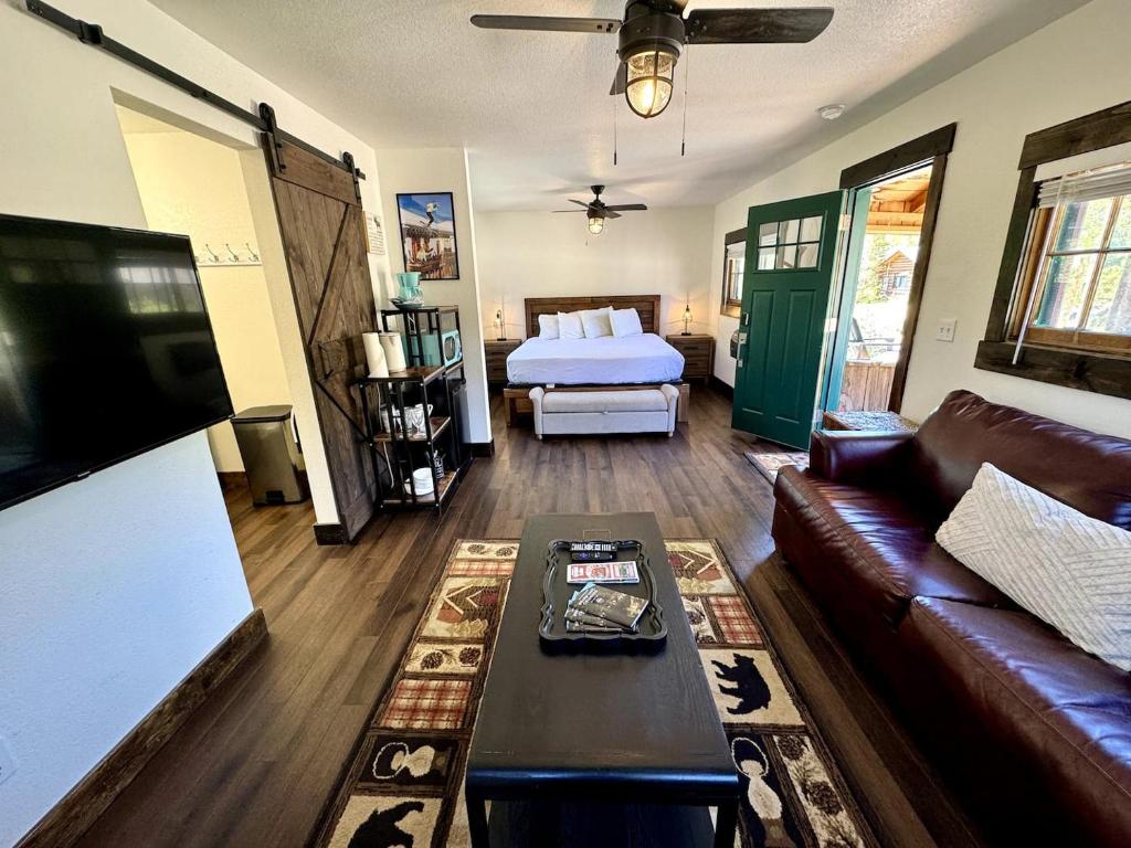 a living room with a couch and a bed at The Loose Moose Cabin #11 At Downtown Grand Lake in Grand Lake