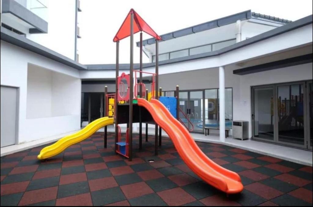 a playground with a slide in a building at Vika Homestay in Brinchang