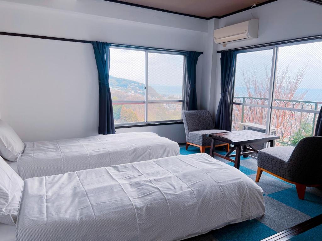 Postel nebo postele na pokoji v ubytování ITO-SPA Guest House YAMATOSO