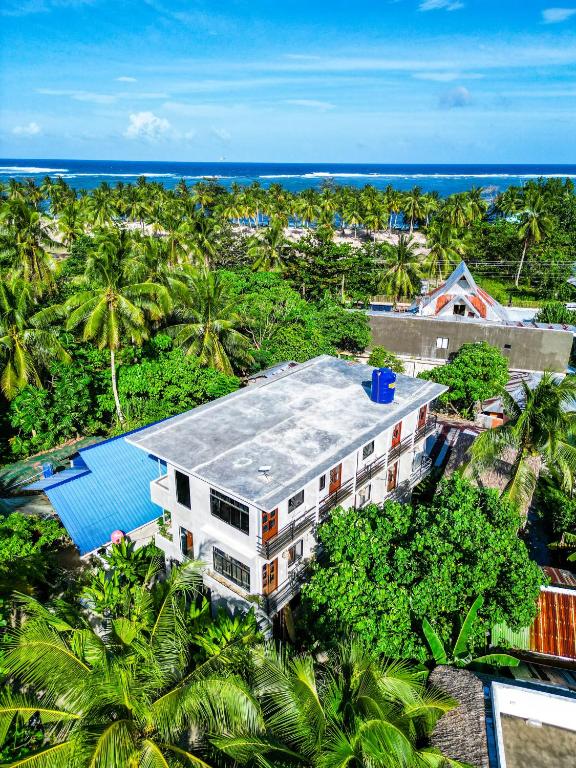 an overhead view of a building with palm trees and the ocean at Hideout Siargao in General Luna