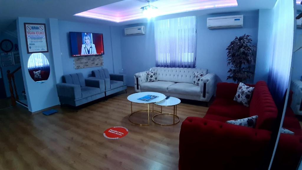 a living room with a couch and a table at Volkii Otel1 in Antalya