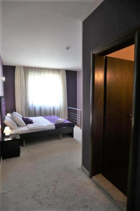 Postel nebo postele na pokoji v ubytování Hotel Neptun