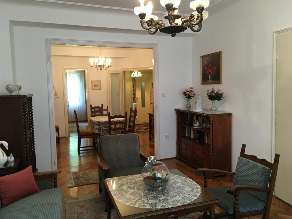 a living room with a table and chairs at Elegant Apartment in Budapest