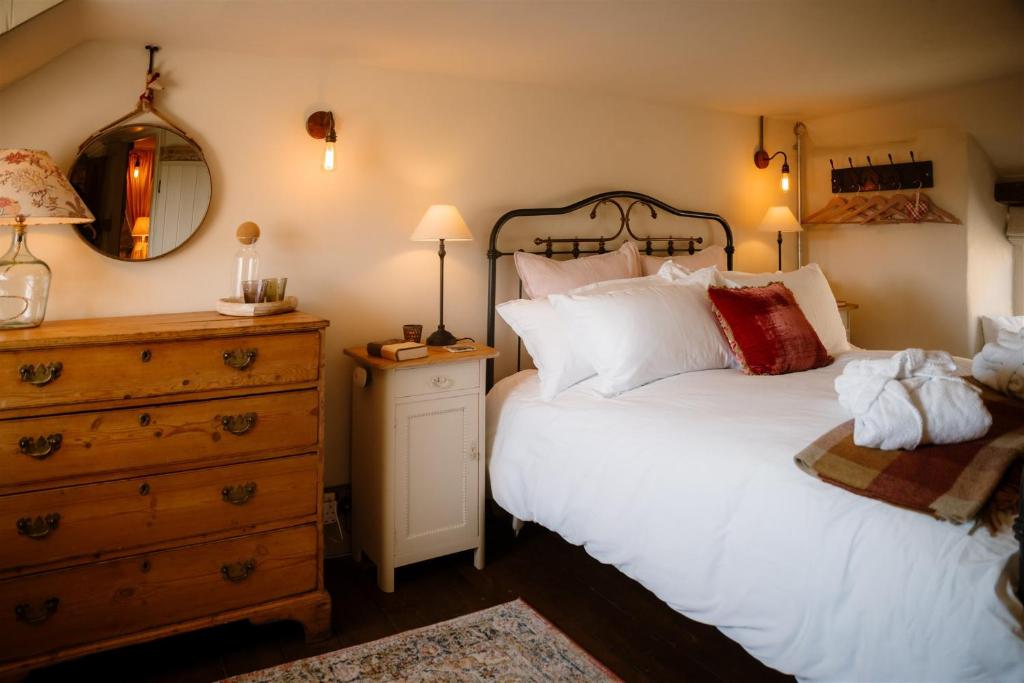 En eller flere senge i et værelse på Button Cottage on Gold Hill - Hovis Hill