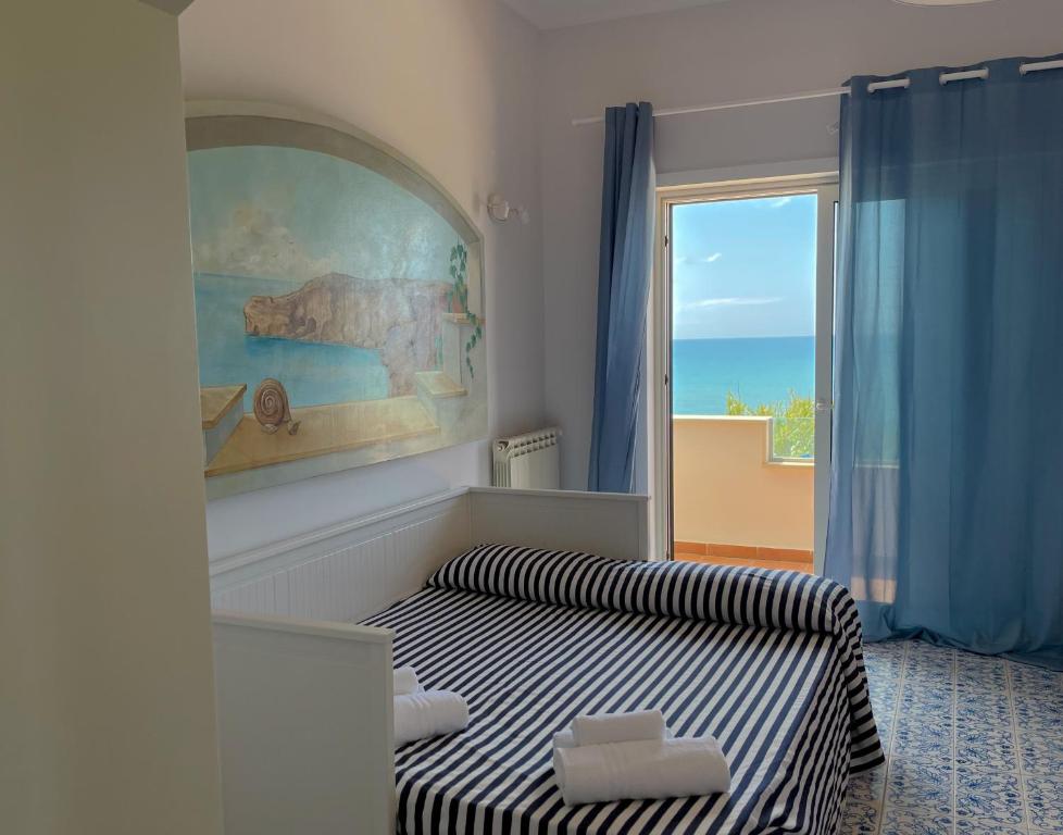 a bedroom with a bed and a large window at LA PERLA BIANCA Apartment - Near Train Station and Best Beaches with Amazing Sunsets in Anzio