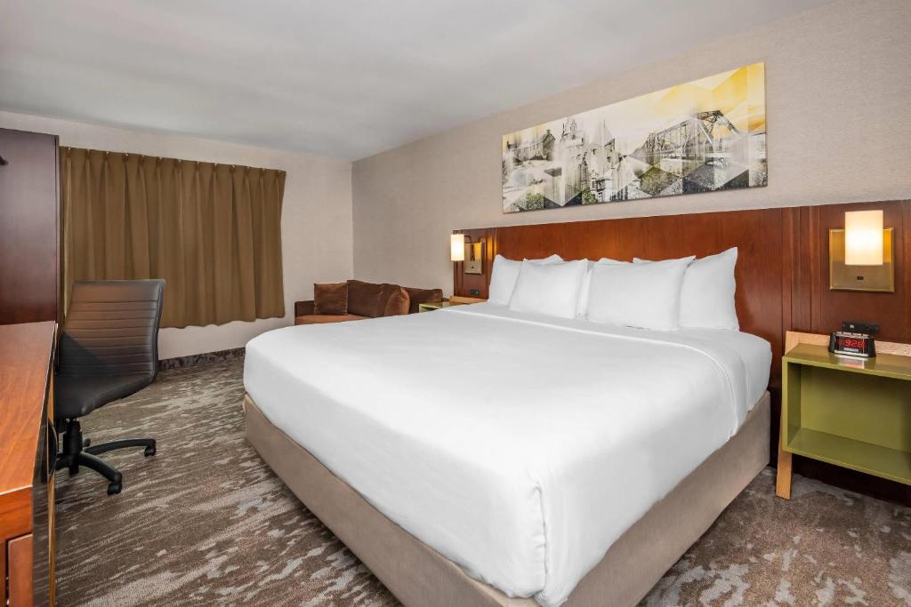 a large white bed in a hotel room at Comfort Inn in Ottawa