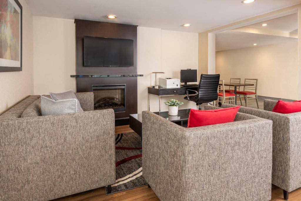 a living room with two couches and a fireplace at Comfort Inn in Ottawa