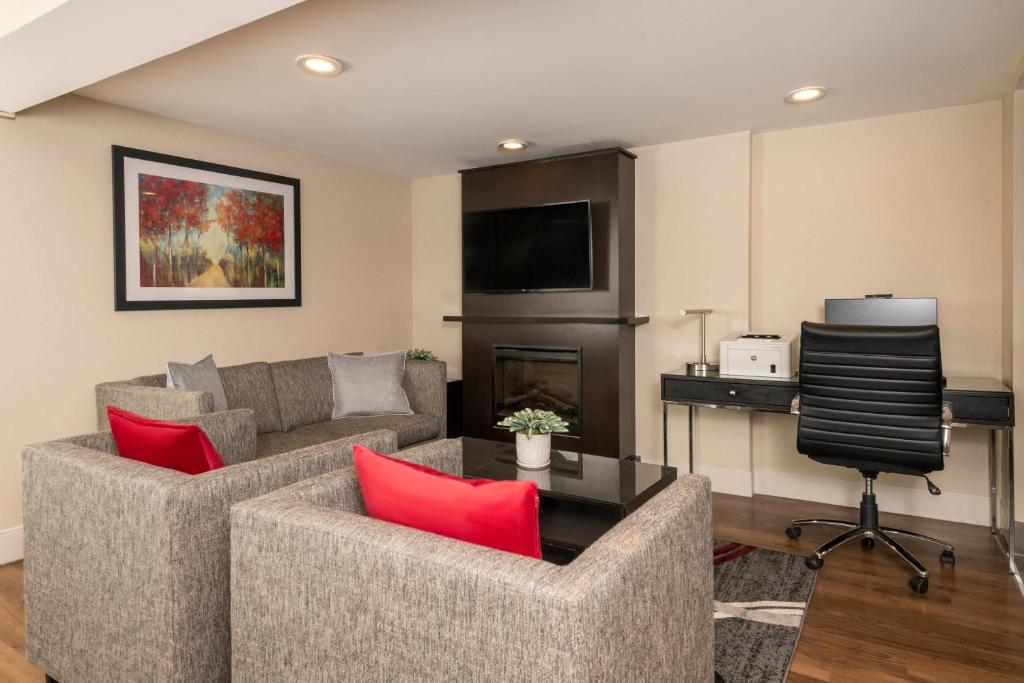 a living room with two couches and a television at Comfort Inn in Ottawa