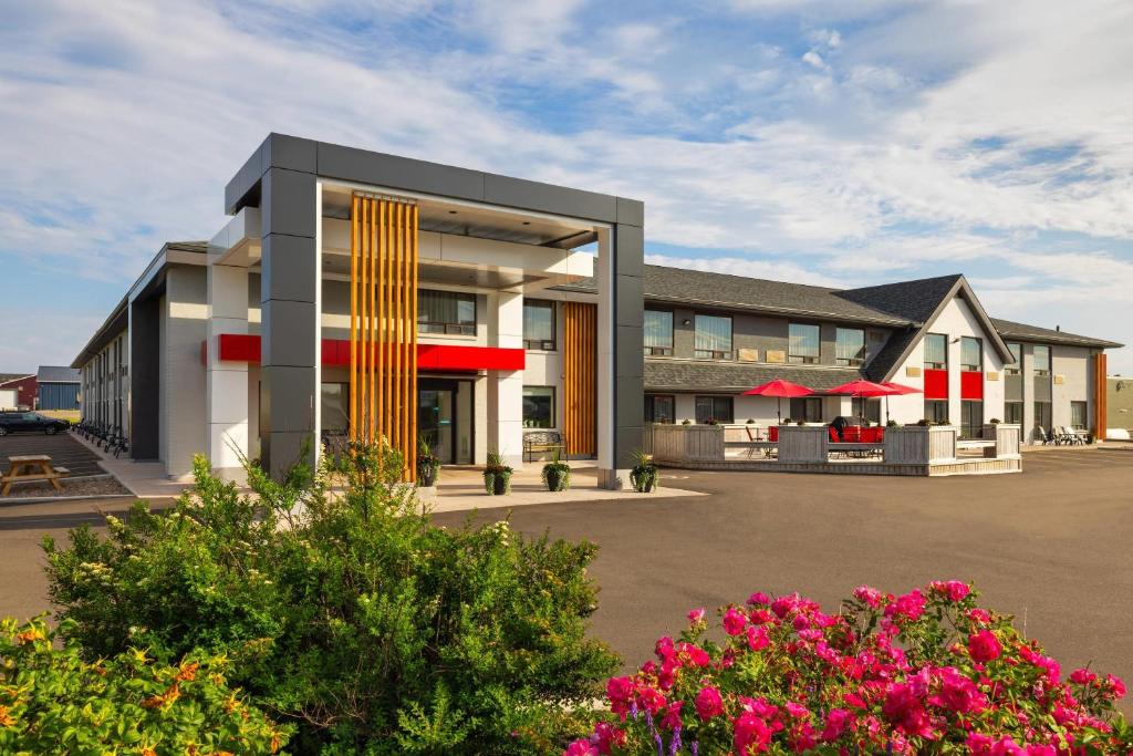 a rendering of a hotel with flowers in front of it at Comfort Inn in Charlottetown