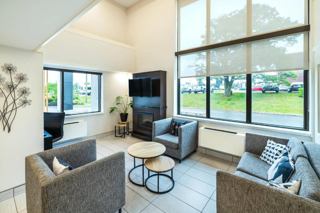 a living room with two couches and a tv at Comfort Inn in Charlottetown
