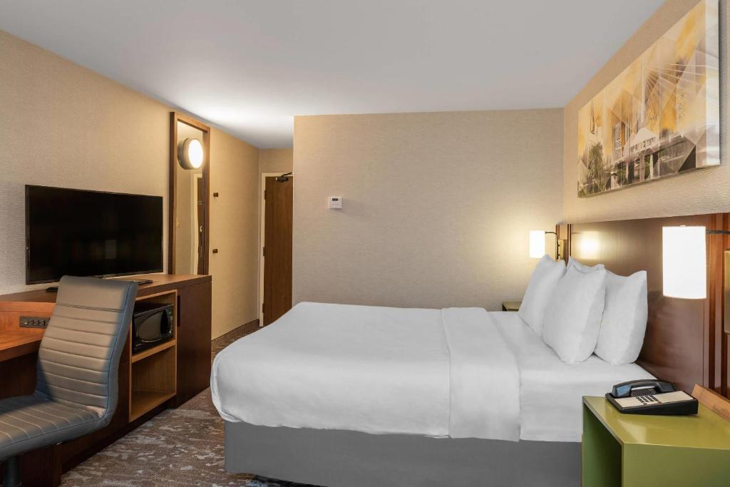a hotel room with a large bed and a television at Comfort Inn in Charlottetown