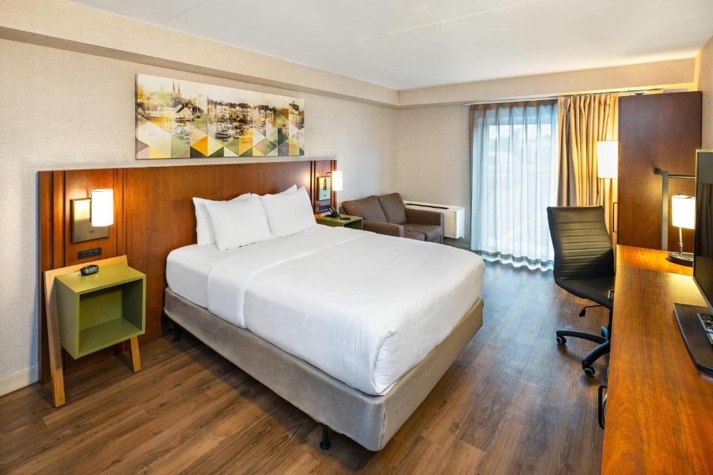 a hotel room with a large bed and a desk at Comfort Inn in Charlottetown