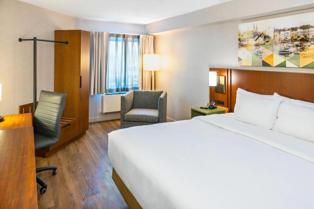 a hotel room with a bed and a desk and a chair at Comfort Inn in Charlottetown