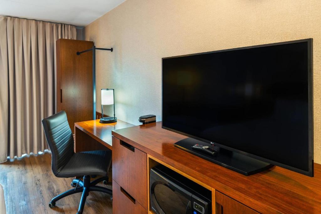 a hotel room with a large flat screen television on a desk at Comfort Inn in Charlottetown
