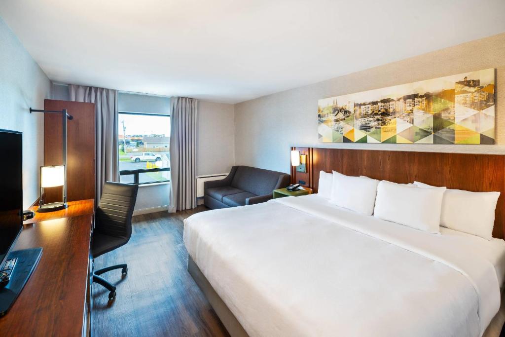 a hotel room with a large bed and a desk at Comfort Inn in Charlottetown