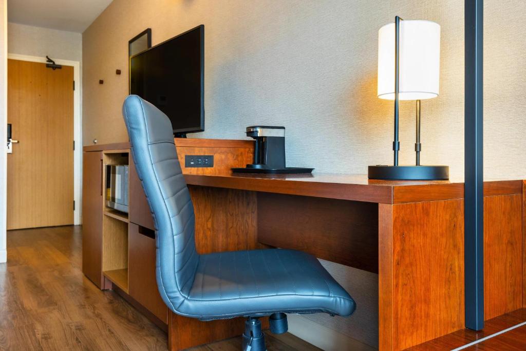 a blue chair sitting at a desk in a hotel room at Comfort Inn in Charlottetown