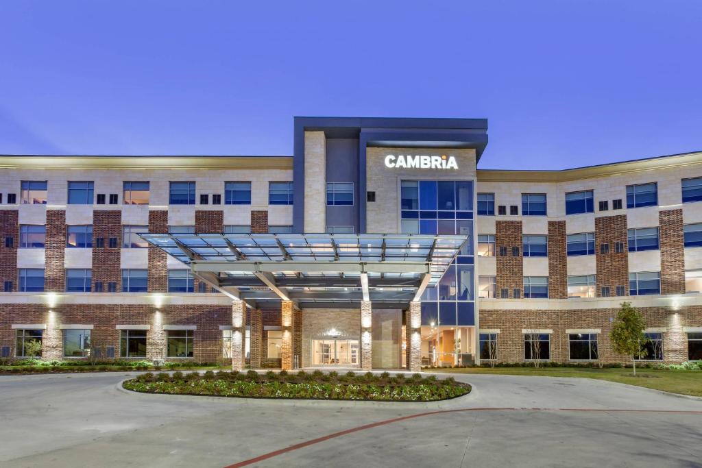 a building with a sign on the front of it at Cambria Hotel Plano - Richardson Garland in Richardson