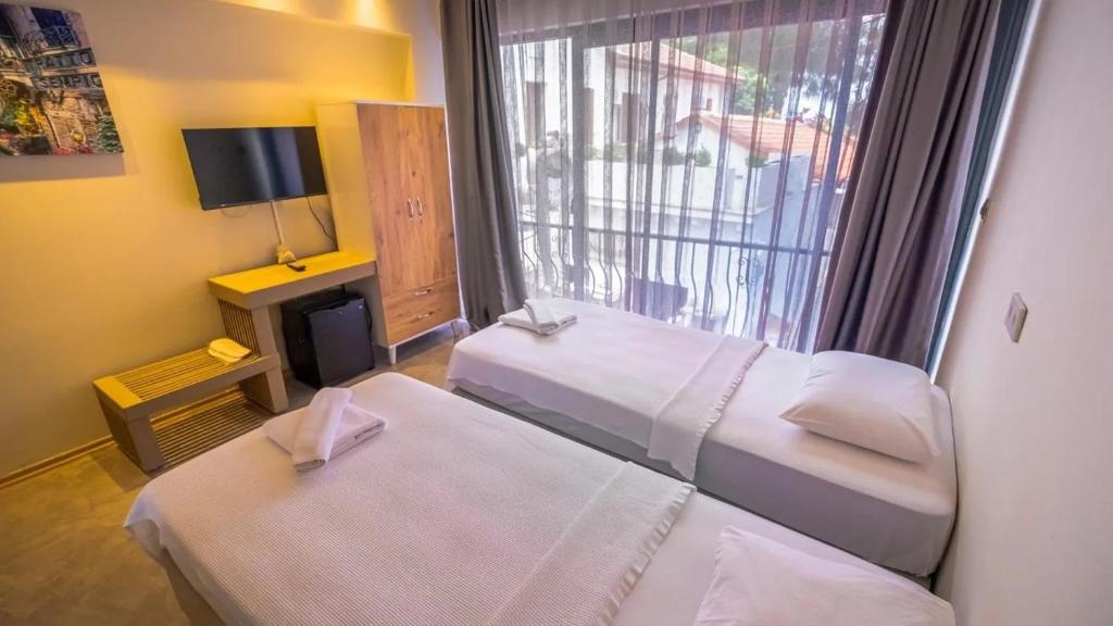 Postel nebo postele na pokoji v ubytování VERA HOTEL KAŞ