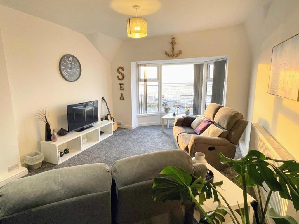 a living room with two couches and a tv at Top Floor Apt Promenade Sea Views Sleeps 6 Shore Vibes in Morecambe