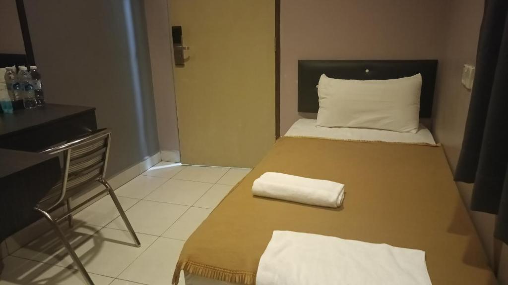 Postel nebo postele na pokoji v ubytování CK Hotel
