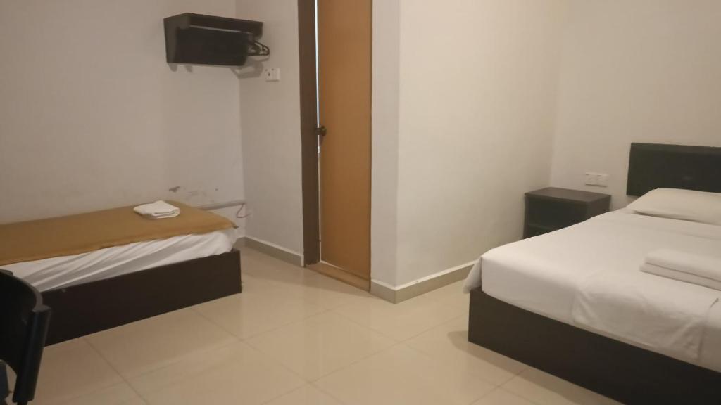 Postel nebo postele na pokoji v ubytování CK Hotel