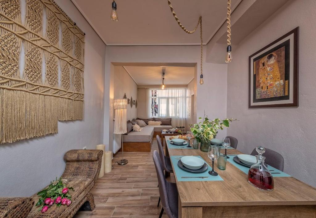 a dining room with a table and a couch at THE RUSTICK HOUSE - TRIKALA near the elf mill in Tríkala