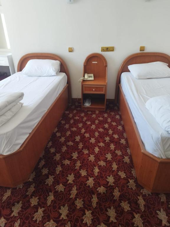 Postel nebo postele na pokoji v ubytování Hotel Birkent