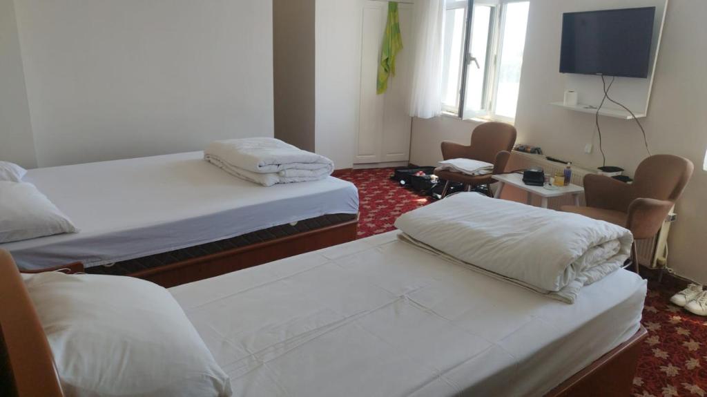 Postel nebo postele na pokoji v ubytování Hotel Birkent