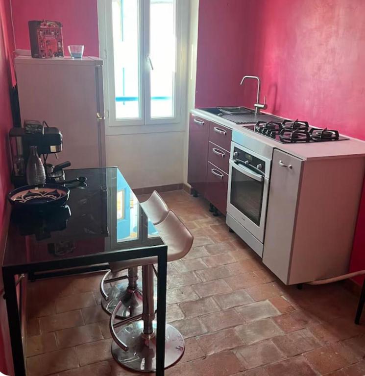 a kitchen with a stove and a table in it at centre ville2 in Marignane