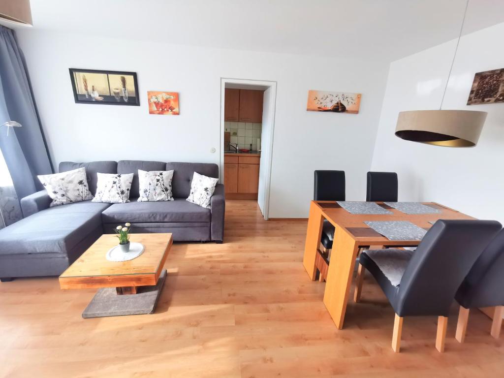 una sala de estar con un sofá y una mesa en BodenSEE Apartment Wasserburg Sonnhaldenstraße, en Wasserburg