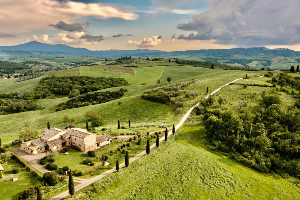 an aerial view of a house in a green field at Podere Montechiari - App Nonna & Maria in Montalcino