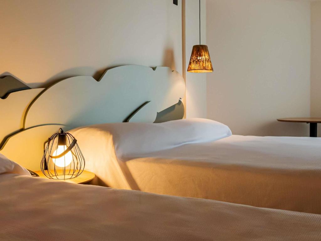 Postel nebo postele na pokoji v ubytování Ibis Styles Maragogi - O primeiro Ibis Styles pé na areia do Brasil