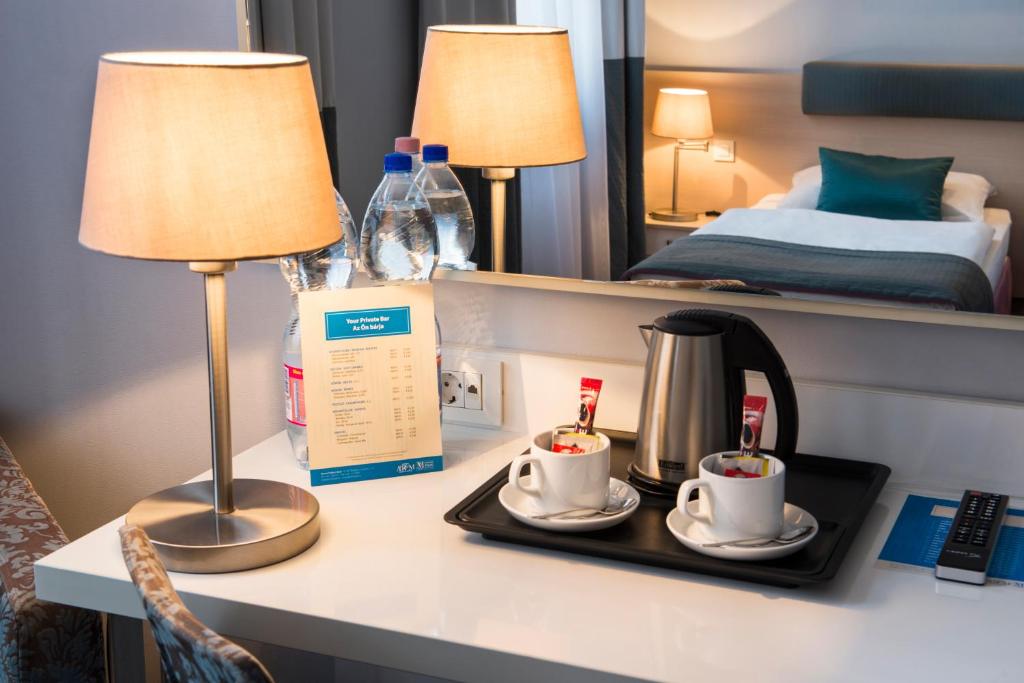 Postel nebo postele na pokoji v ubytování Atrium Fashion Hotel