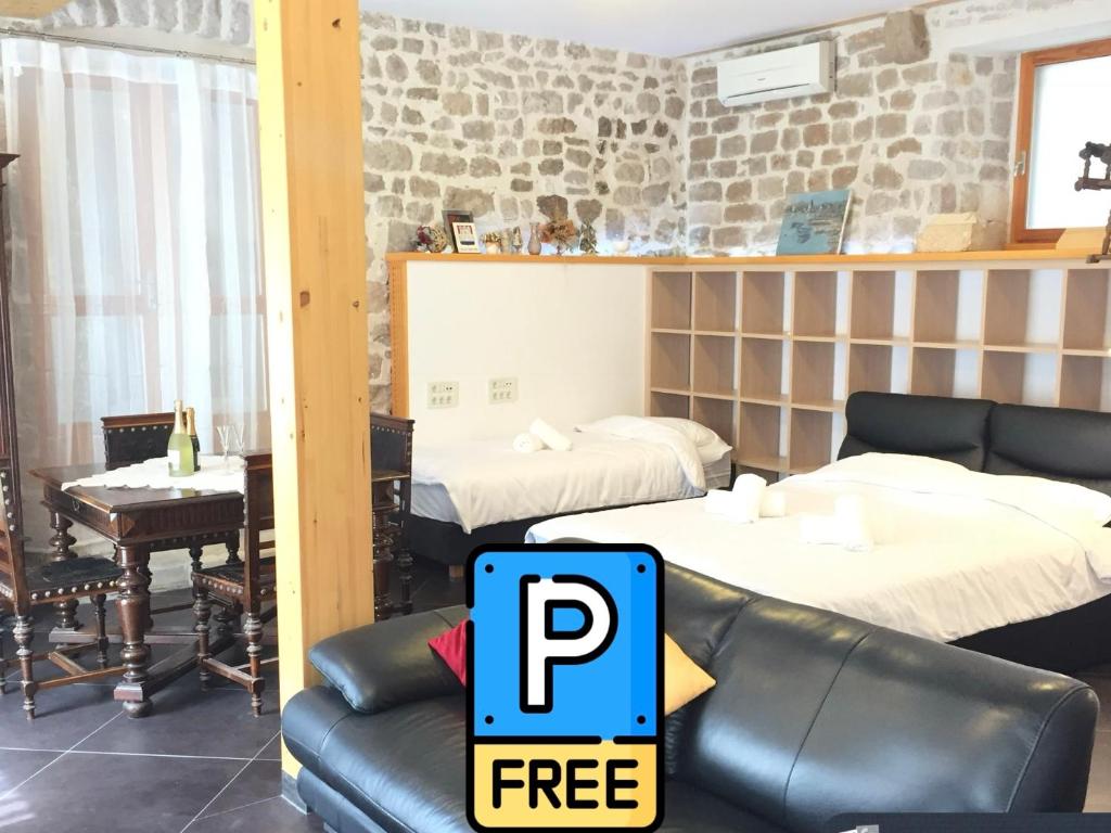 a room with two beds and a table and a couch at Galera I in Šibenik