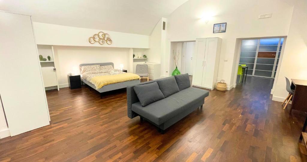 a living room with a couch and a bed at Antica Muraglia Apartments in Molfetta