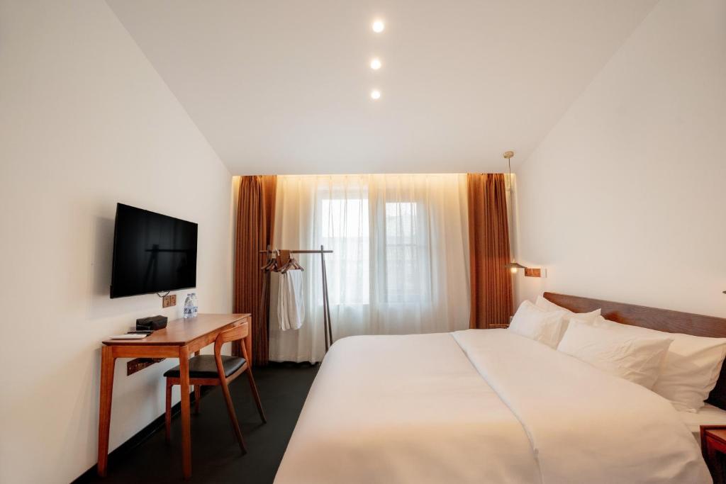 TV a/nebo společenská místnost v ubytování Xingle Hotel-Suzhou Guanqian Street Pingjiang Road