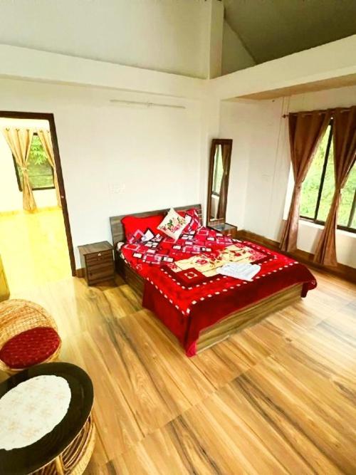 a living room with a red bed in a room at Nehal Royal Homestay in Kalimpong