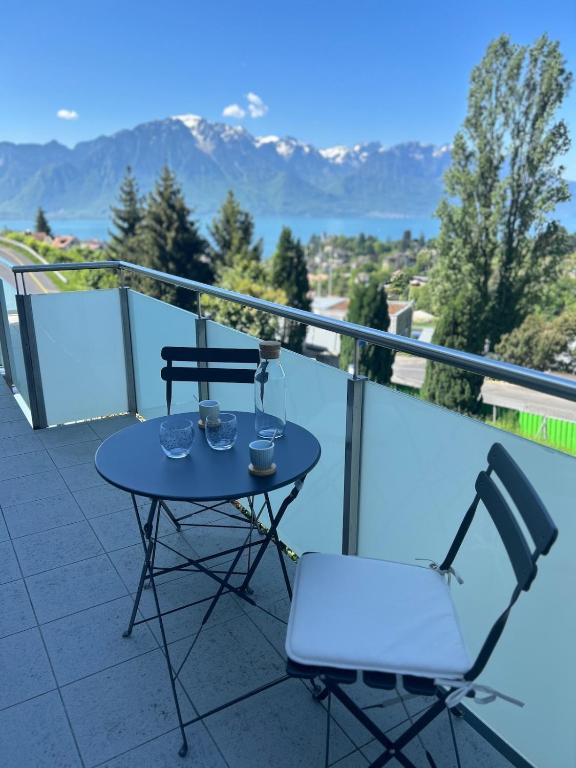 a table and chairs on a balcony with a view at Montreux panoramic view with garden in Montreux