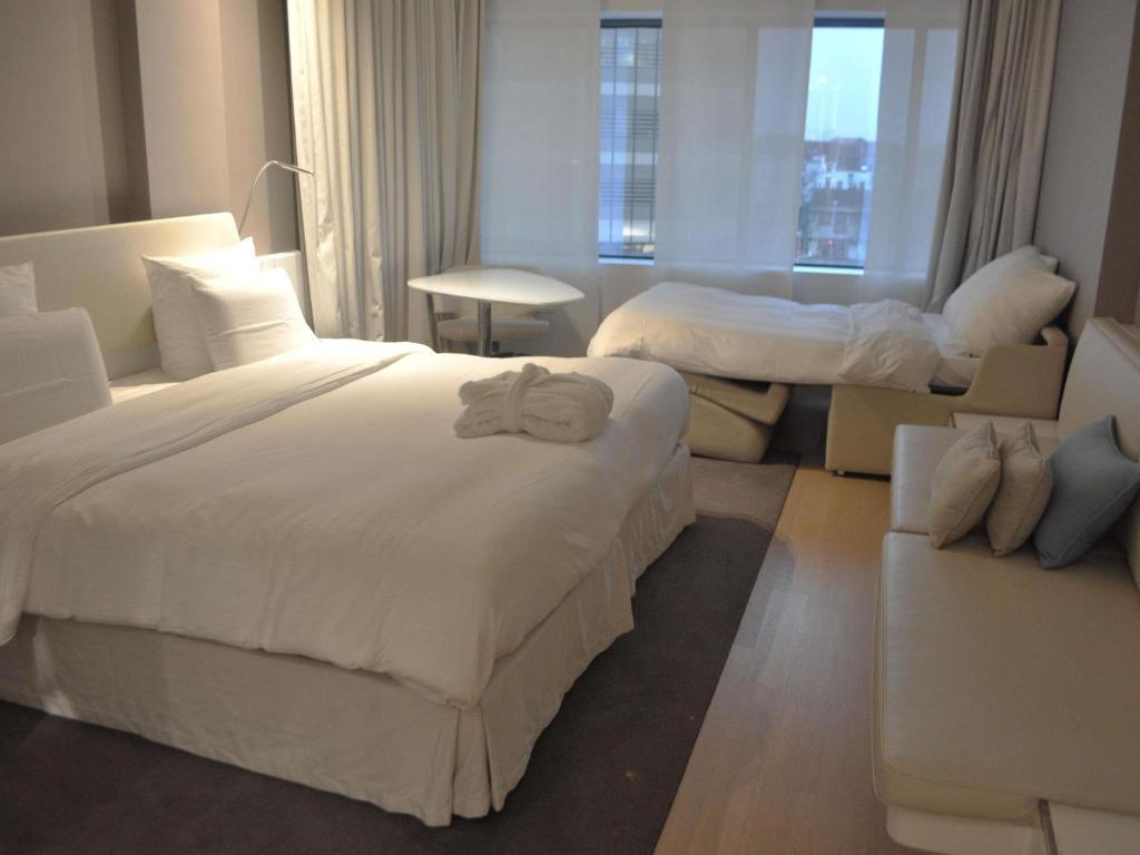 Postel nebo postele na pokoji v ubytování Pullman Brussels Centre Midi
