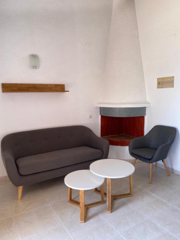 a living room with a couch and a fire place at Apartamentos LLorca in Platja de l’Almadrava