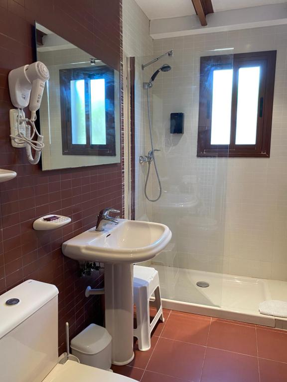 a bathroom with a sink and a shower at Apartamentos LLorca in Platja de l’Almadrava
