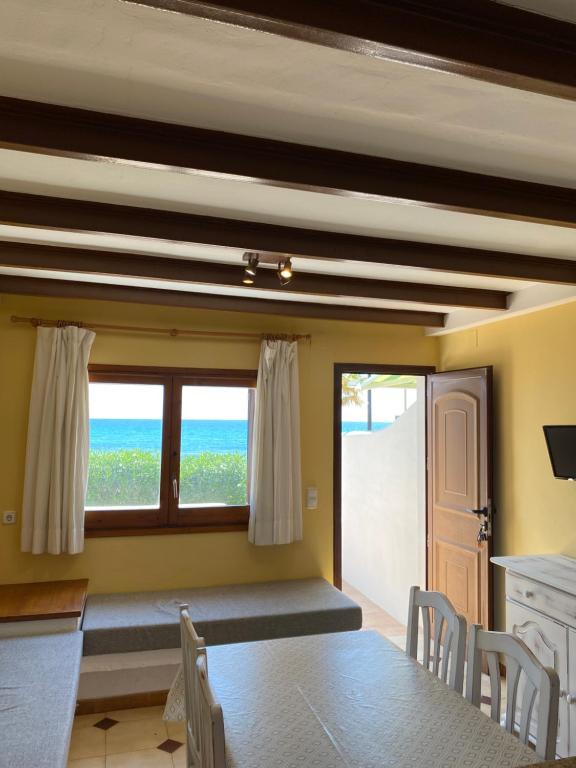 a dining room with a table and a view of the ocean at Apartamentos LLorca in Platja de l’Almadrava