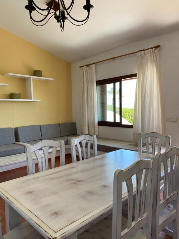 a dining room with a table and chairs at Apartamentos LLorca in Platja de l’Almadrava