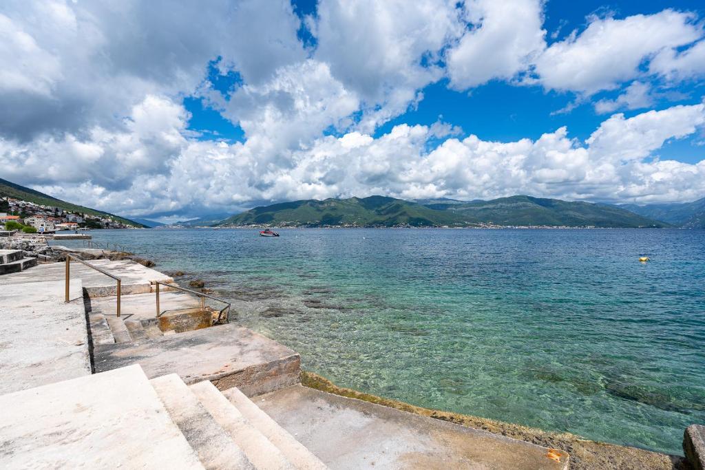 a view of a large body of water with mountains at Simphony Apartments in Tivat