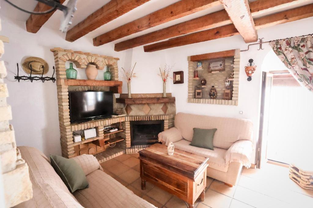a living room with a couch and a fireplace at Casa Thula - Hello Vejer in Vejer de la Frontera