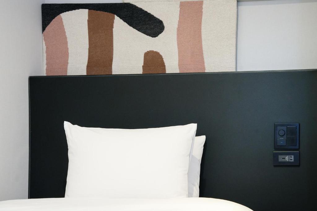 Postel nebo postele na pokoji v ubytování WPÜ HOTEL Shinjuku