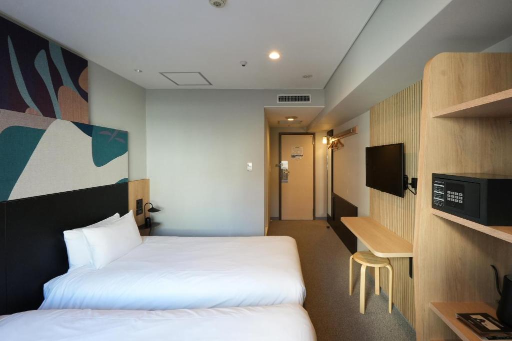 Postel nebo postele na pokoji v ubytování WPÜ HOTEL Shinjuku