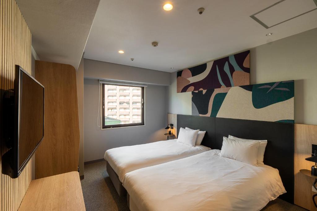 Postel nebo postele na pokoji v ubytování WPÜ HOTEL Shinjuku