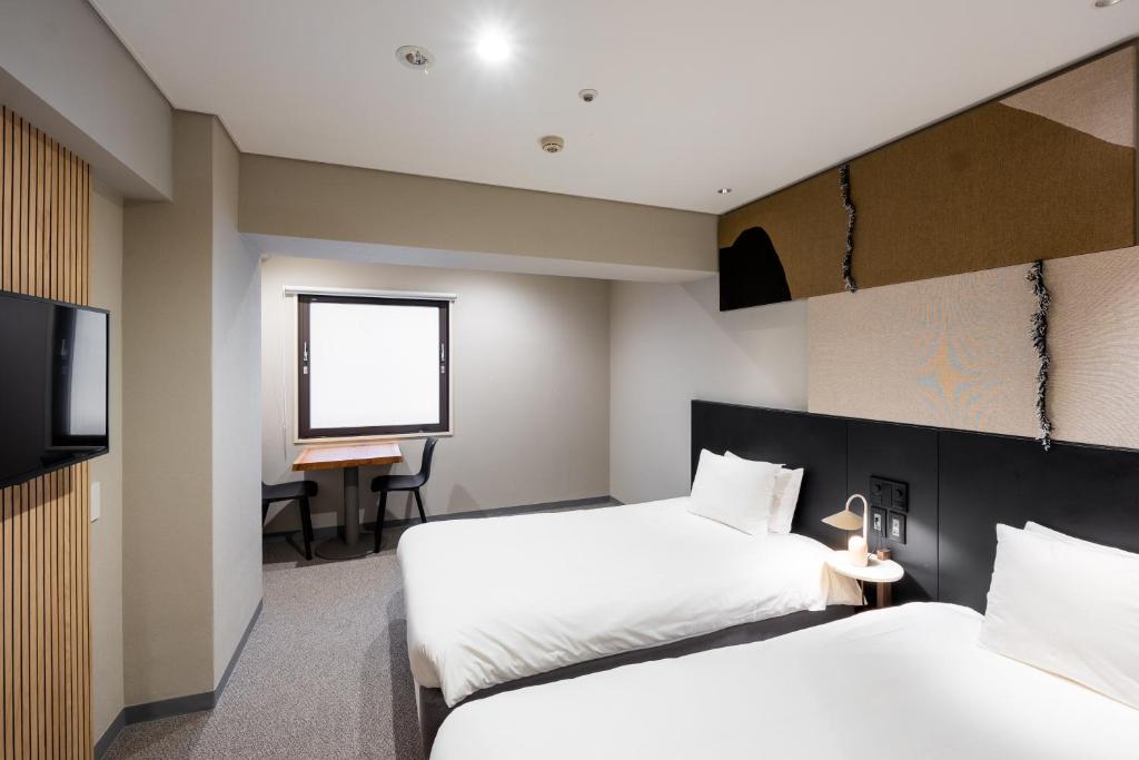 Postel nebo postele na pokoji v ubytování WPÜ HOTEL Shinjuku